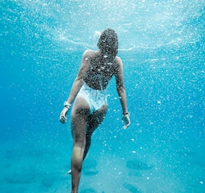 woman swimming under water