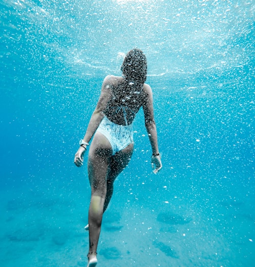 woman swimming under water