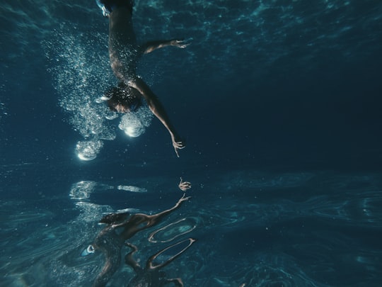 man swimming underwater in Ibiza Spain