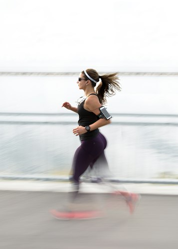 A wearable fitness sensor strapped to a runner's leg during an outdoor training session