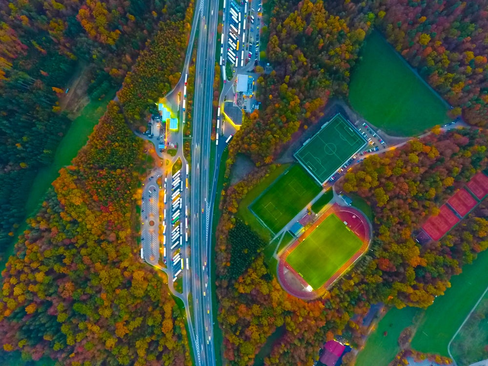 aerial photography of road, soccer field, and football field