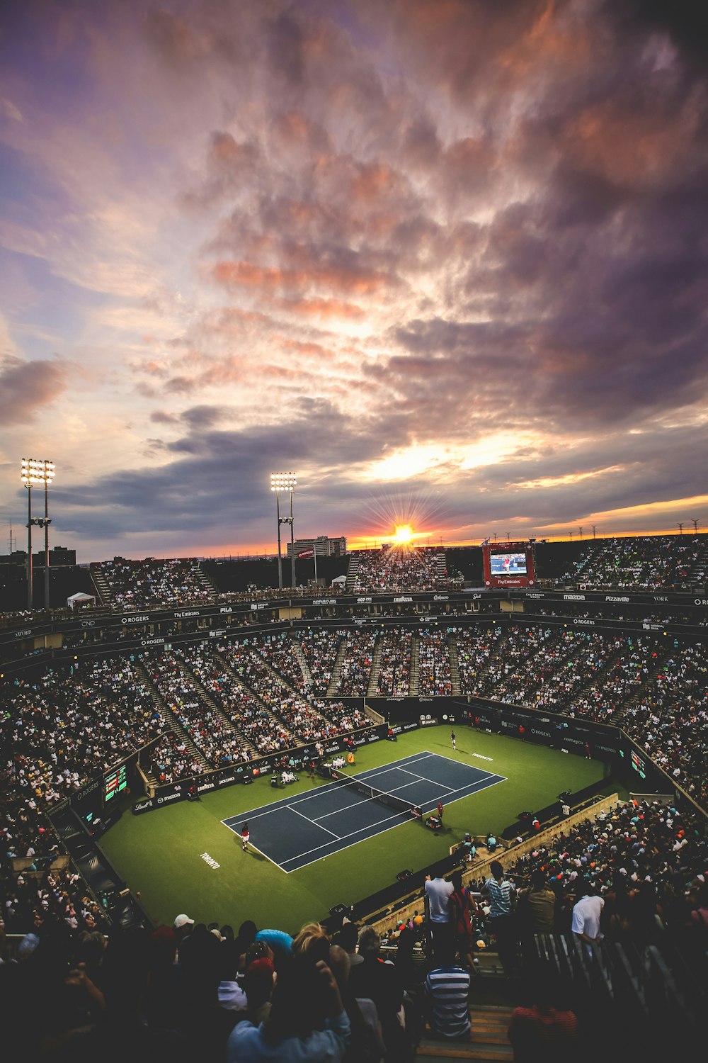 people at the tennis court stadium during sunset