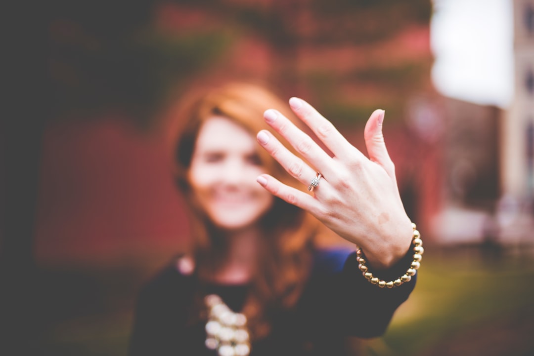 woman showing silver-colored ring