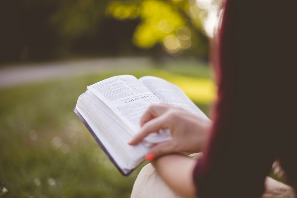 selective focus photography of person reading book photo – Free Person  Image on Unsplash