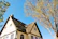 A charming home exterior showcasing a crisp, clean paint finish under a clear blue sky.