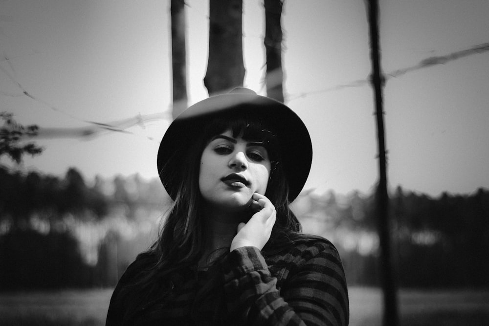 grayscale photography of woman wearing sweater standing