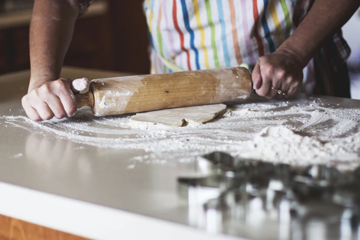 Hands rolling out dough during a baking session