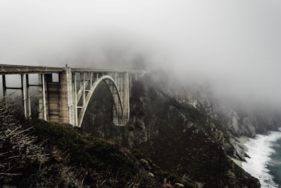 white concrete bridge covered with fogs dense zoom background