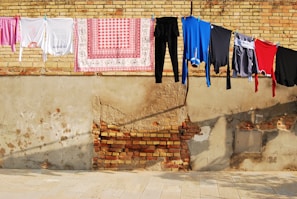Brightly colored towels hanging to dry in the sunlight outdoors.