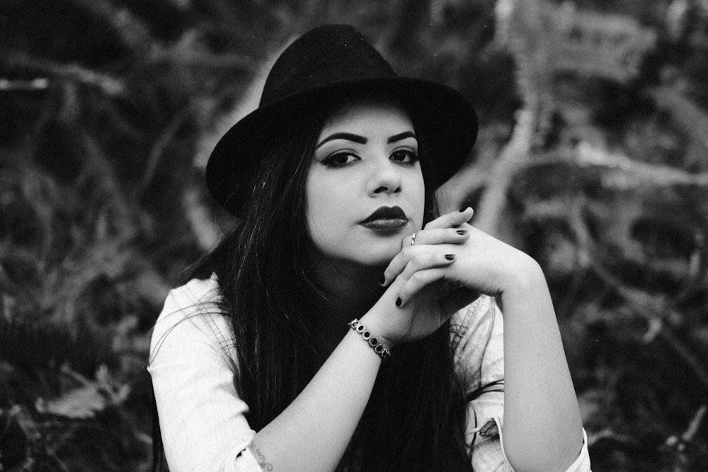 grayscale photo of woman sitting on ground