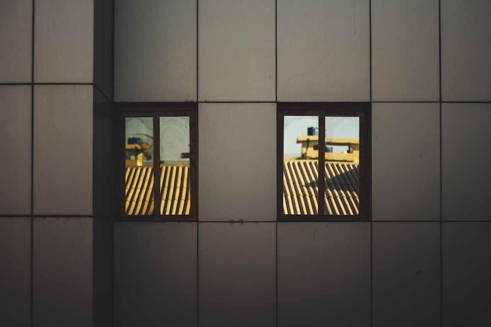 two windows viewing roofs during day