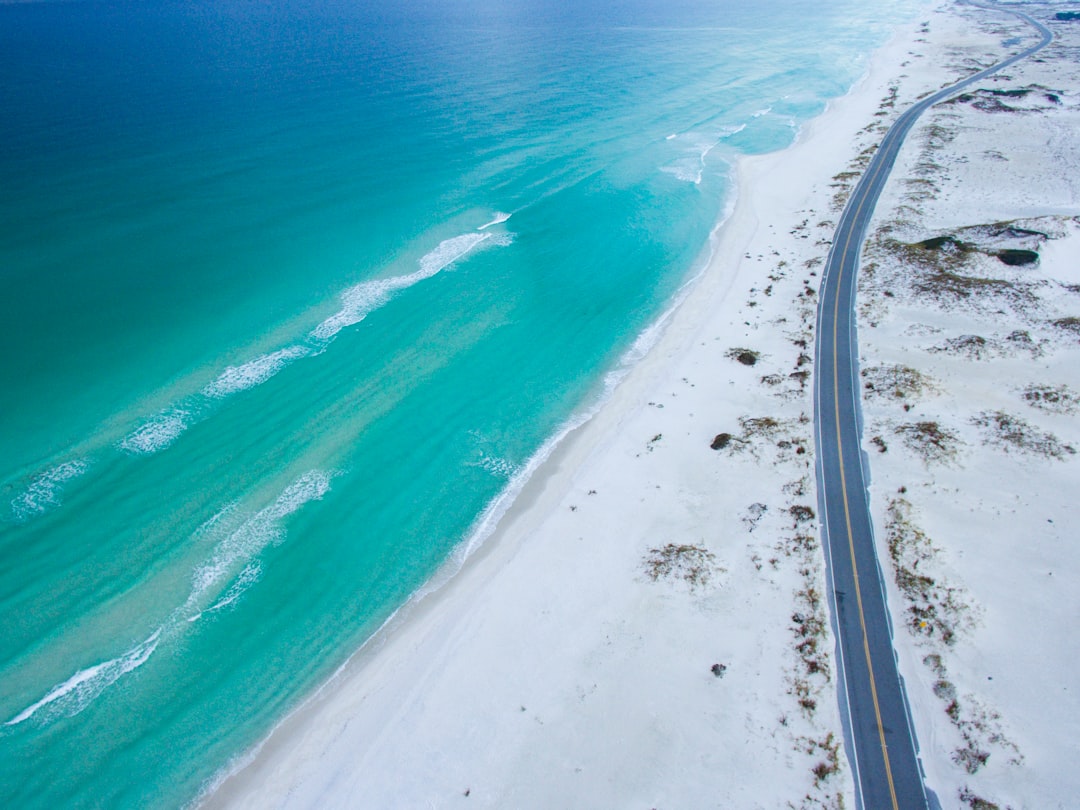 aerial photo of beach near road during daytime