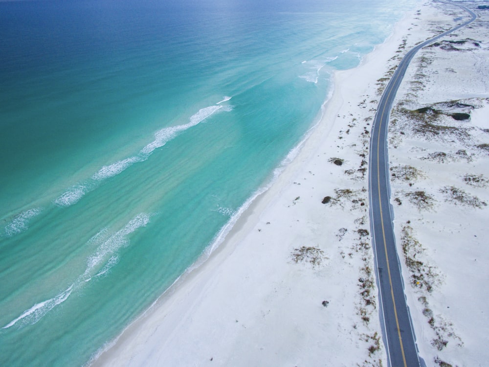 aerial photo of beach near road during daytime