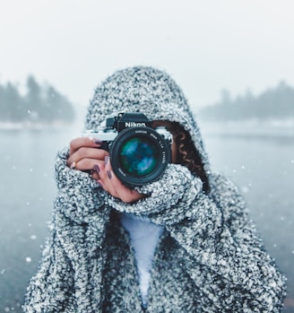 woman using Nikon DSLR camera