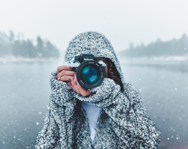 woman using Nikon DSLR camera