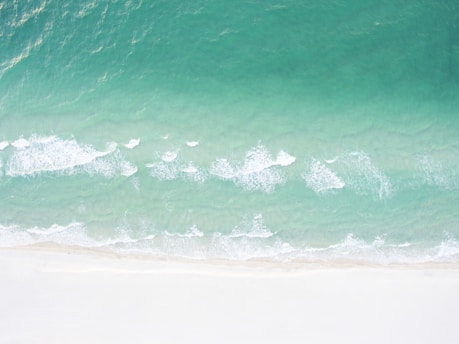 A serene view of a secluded beach in Eleuthera, with crystal clear water and soft white sand, perfect for relaxation.