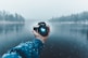 person taking selfie using Nikon DSLR camera