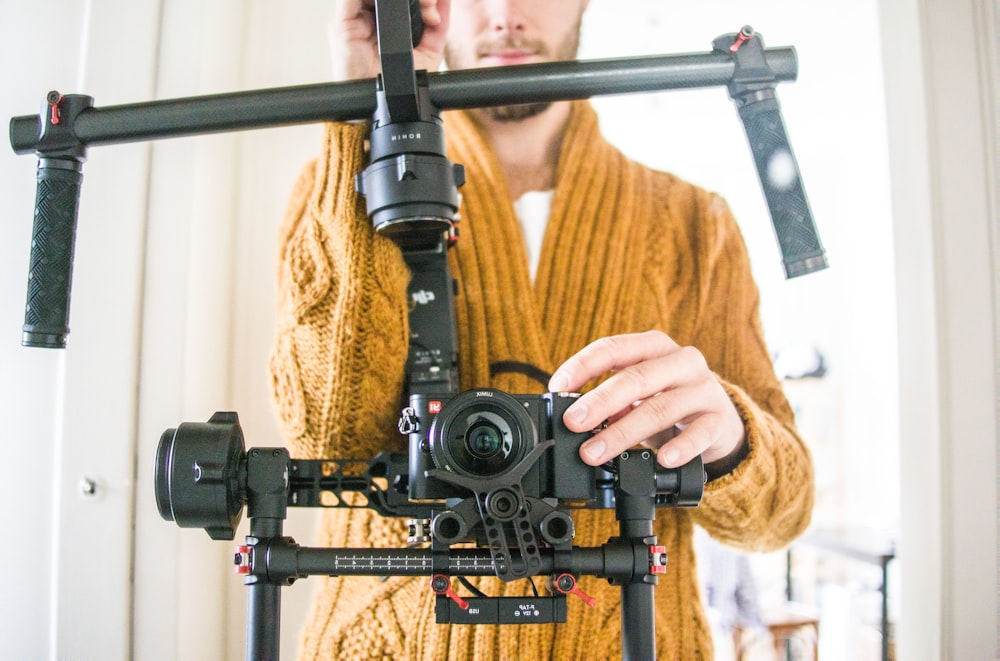 man holding black studio camera set