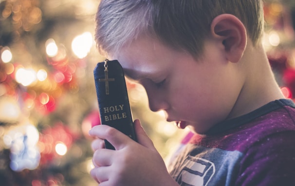 boy holding Holy Bible