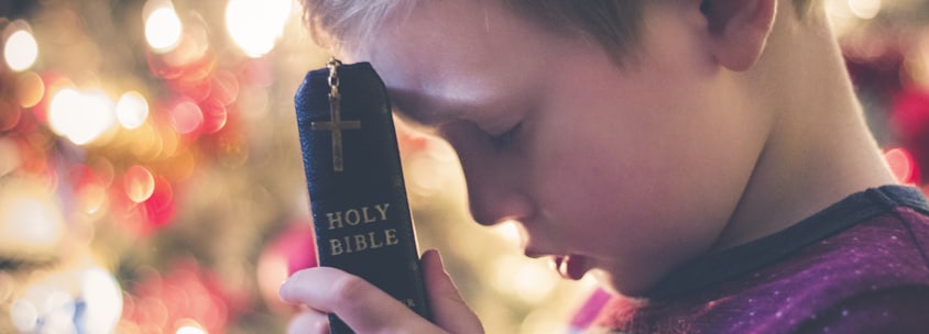 boy holding Holy Bible