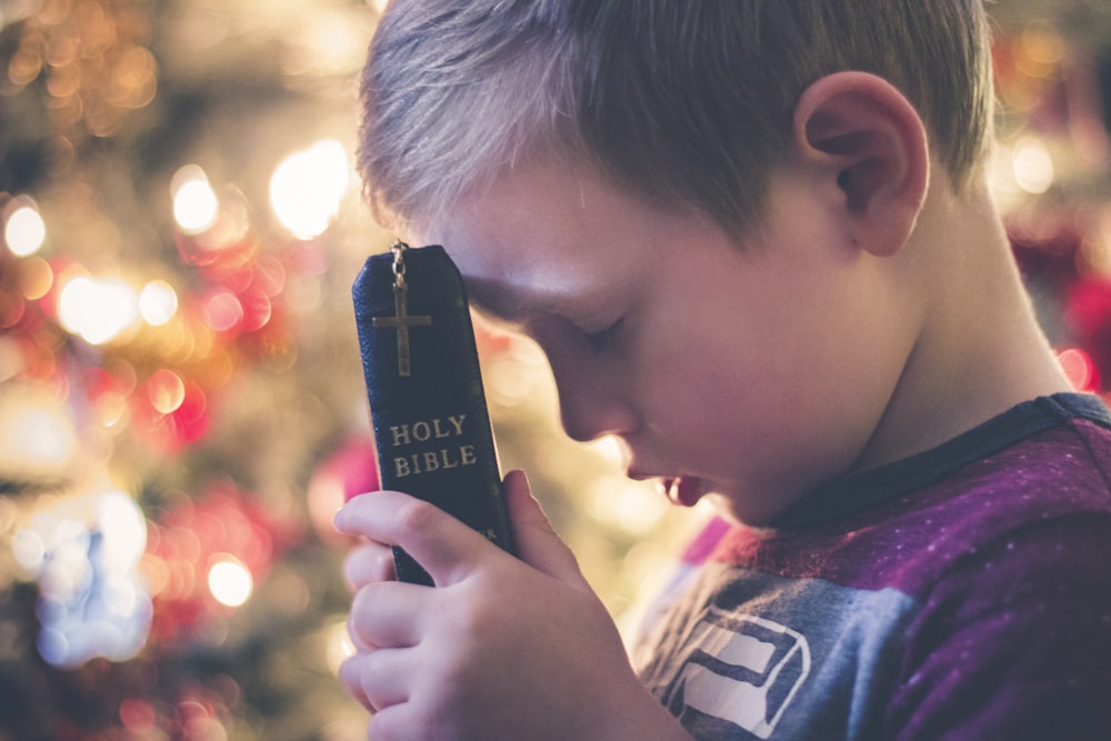 boy holding Holy Bible