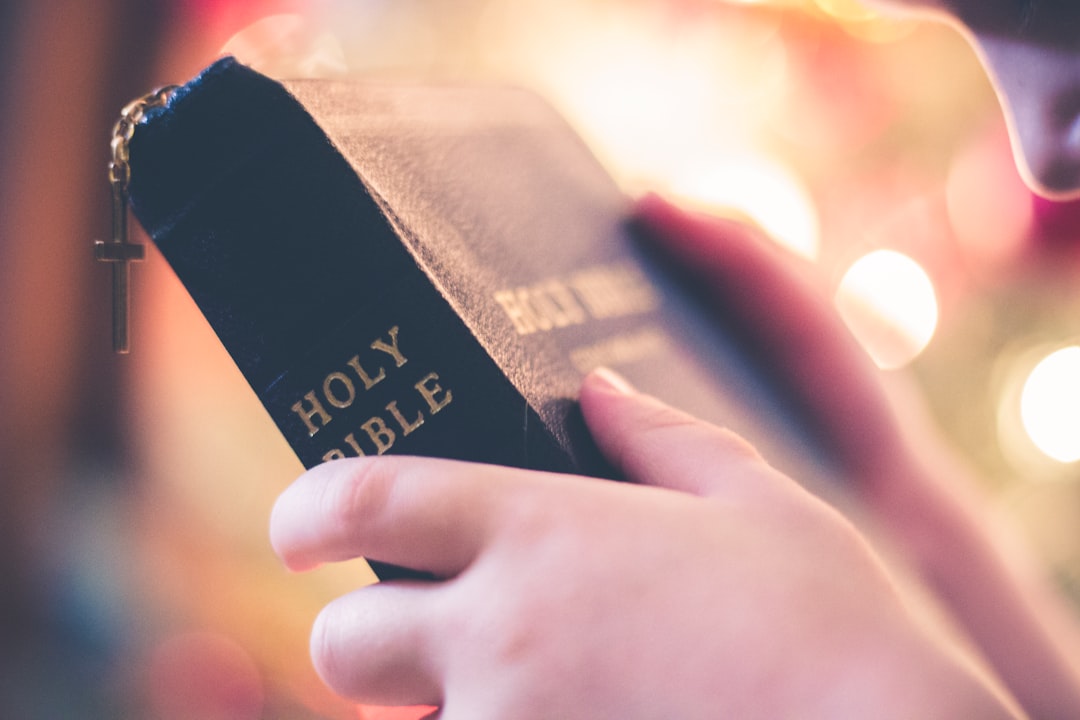 A person holding the Holy Bible.