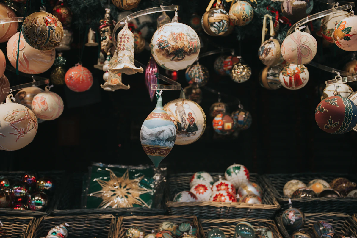 Rows of glass Christmas ornaments hanging on display in a shop