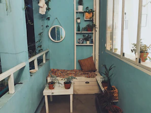A stylish corner nook with plants and cozy seating, perfect for quiet moments.