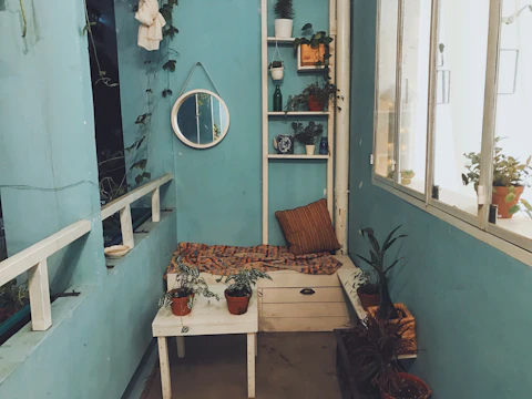 Bright kitchen nook featuring colorful ceramic planters.