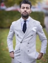 man in white and black pinstripe suit jacket