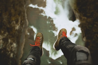person sitting on cliff