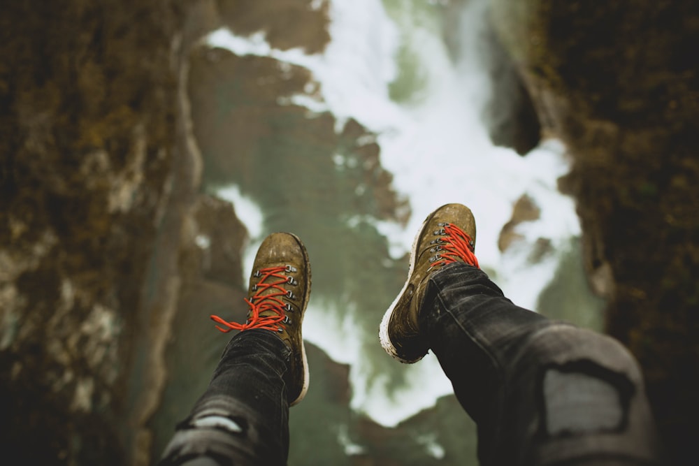 person sitting on cliff