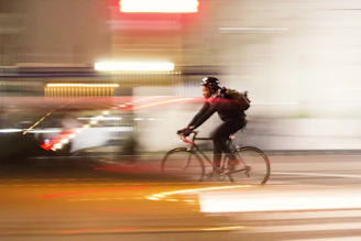 Dynamic shot of a cyclist sporting xneuron glasses, with a blurred background showing speed.