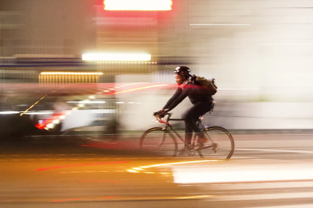 Dynamic shot of a cyclist sporting xneuron glasses, with a blurred background showing speed.