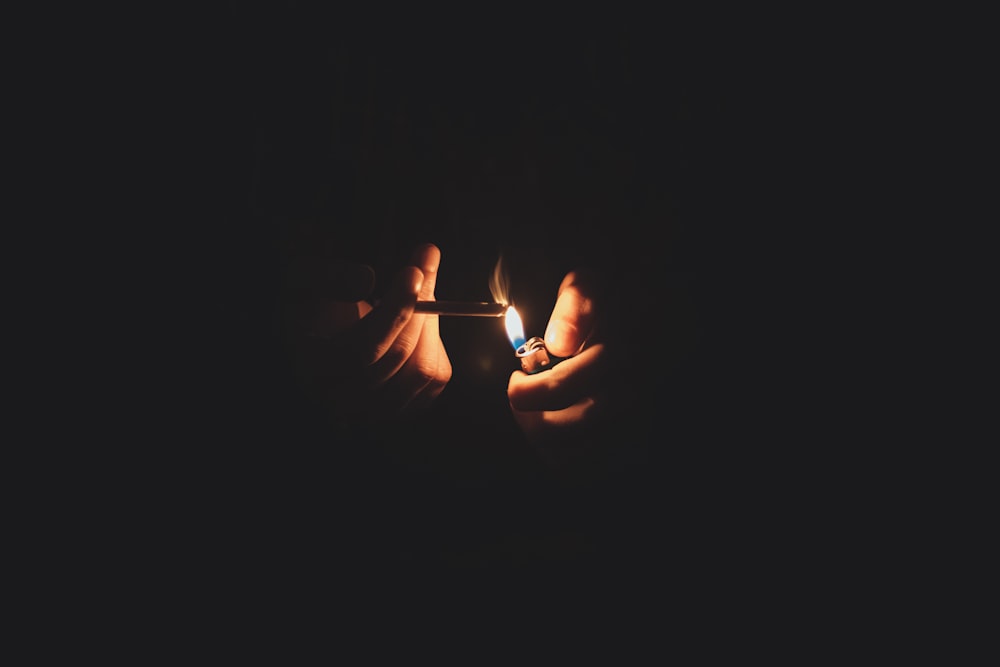 person lighting cigarette