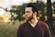 man wearing maroon V-neck t-shirt in forest