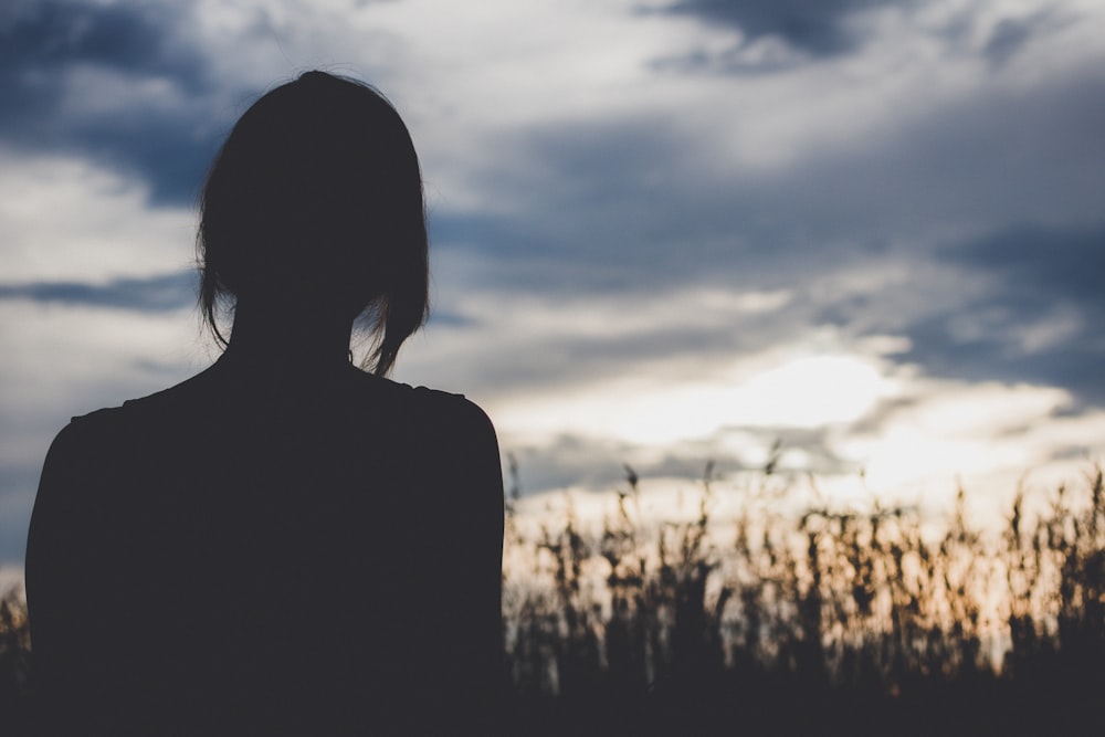 silhouette photography of woman in front of wheat plants