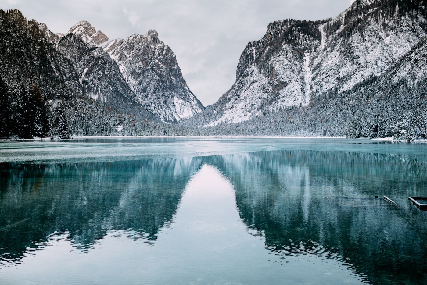 Snow-covered New Hampshire mountains above a still winter lake — the backdrop for a winter car rental in New Hampshire ski trip