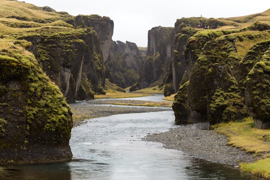 body of water between mountain in Fjaðrárgljúfur Iceland