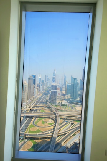 View from deluxe suite window overlooking bustling city streets and nearby hospitals.