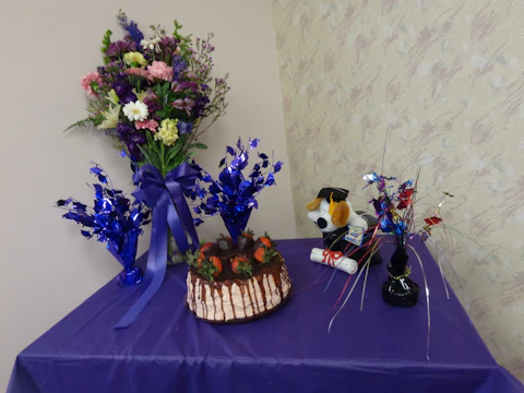 Colorful graduation party with tables, chairs, and festive balloons