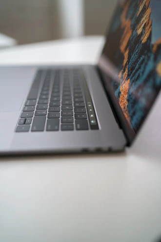 Close-up photo of a sleek modern laptop with a vibrant screen displaying software analytics