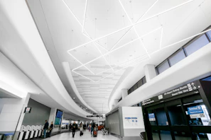 A sleek modern airport terminal bustling with travelers and vibrant signage.