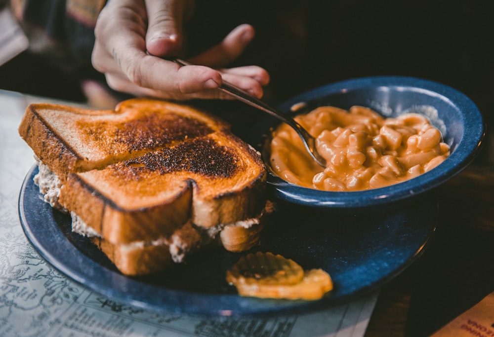 plate of toasted bread and bowl of pork and beans