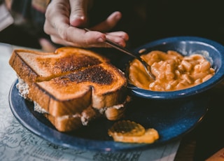 plate of toasted bread and bowl of pork and beans