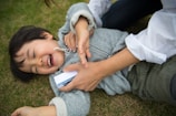 A smiling child interacting with a therapist during a session.