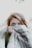 woman hiding her face with scarf