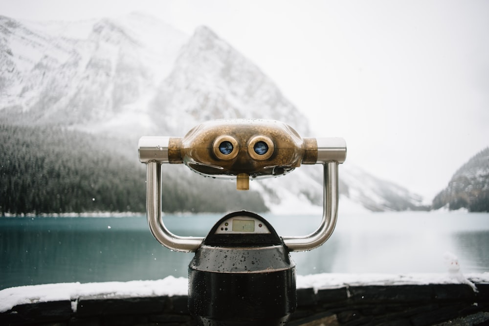 silver digital device on boat beside mountain