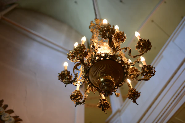 Elegant classic chandelier hanging in a warmly lit living room
