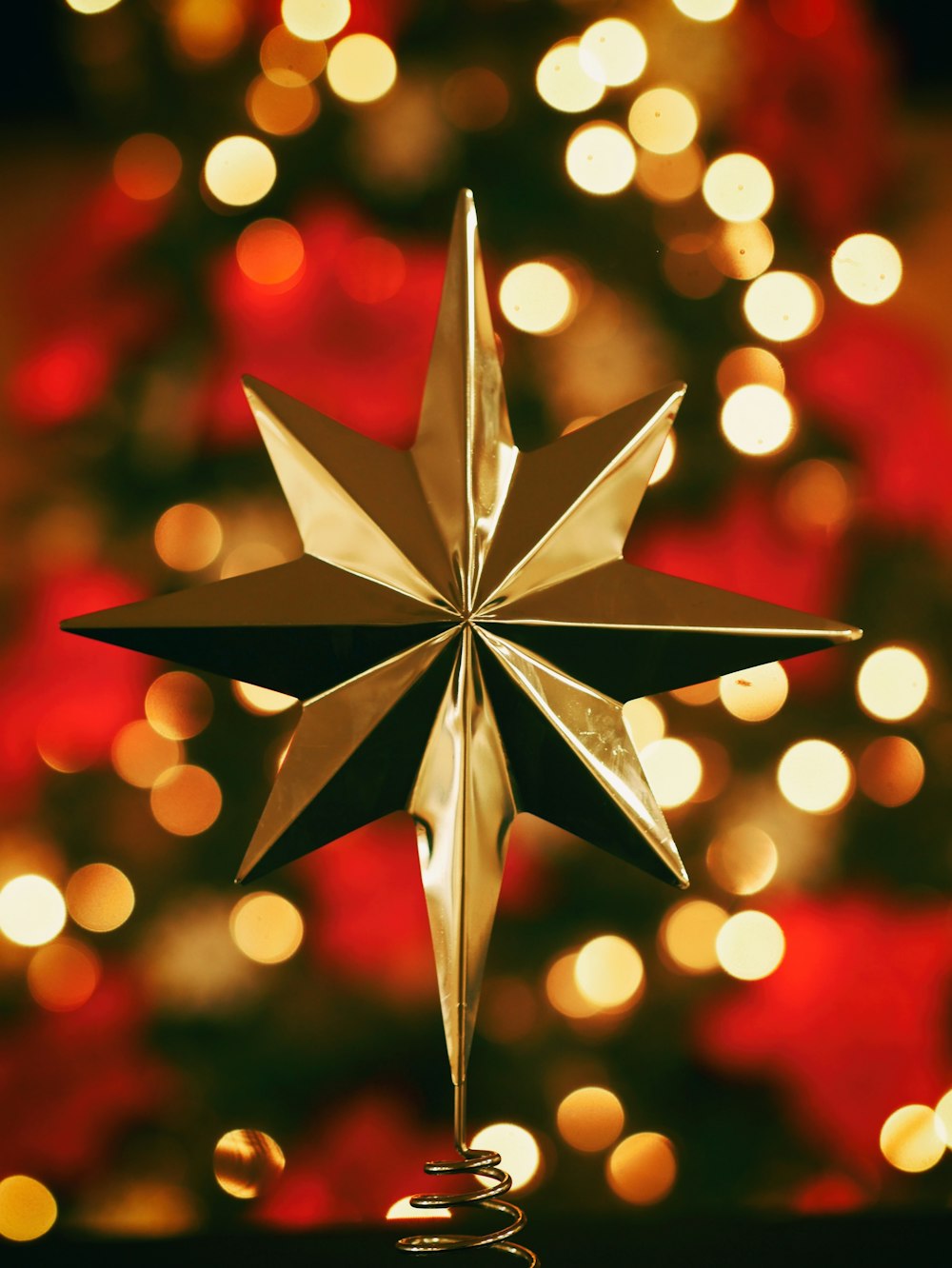 bokeh photography of gold star tree topper
